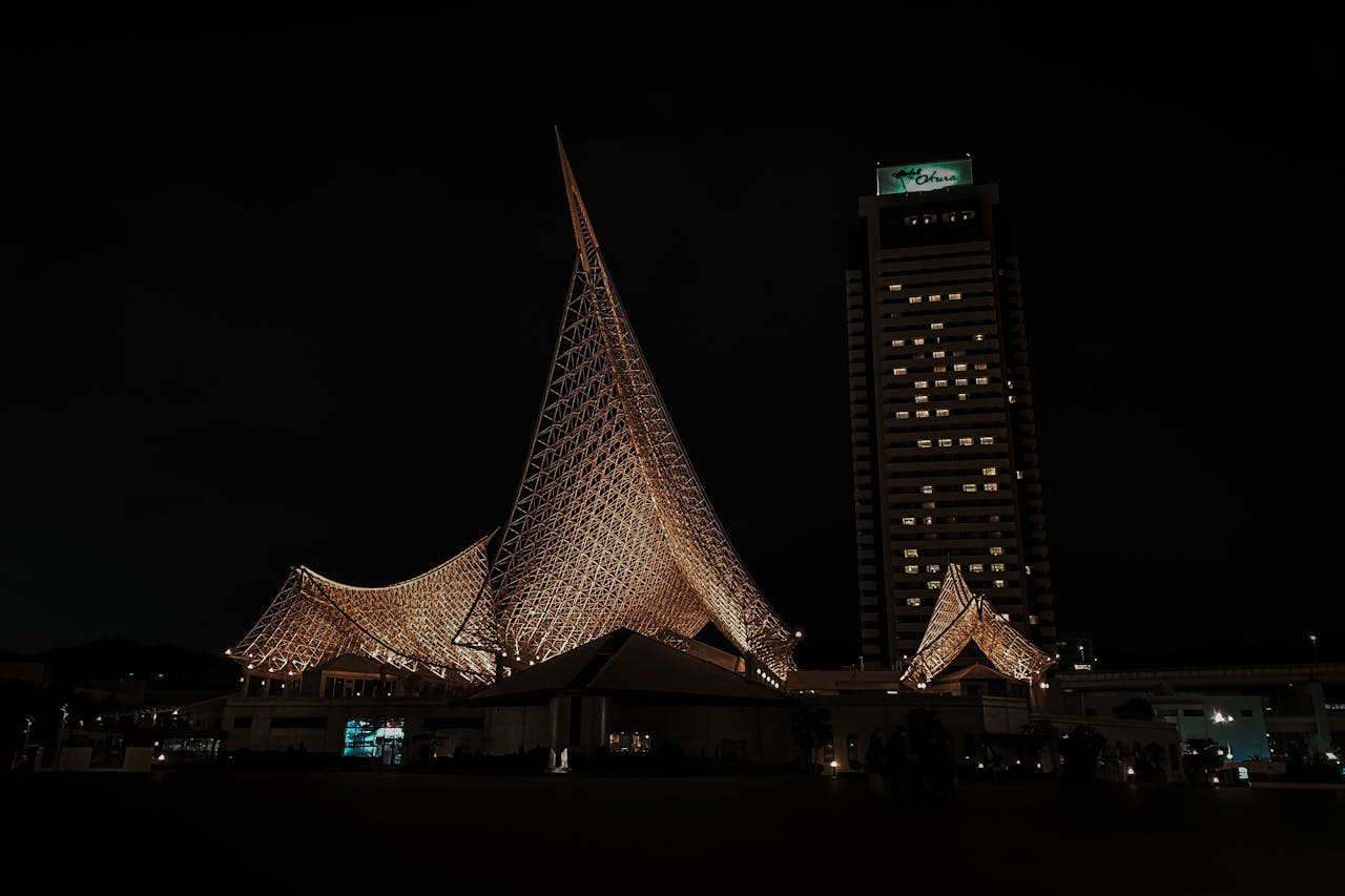 Stunning night view of the illuminated Kobe Maritime Museum in Japan's cityscape.