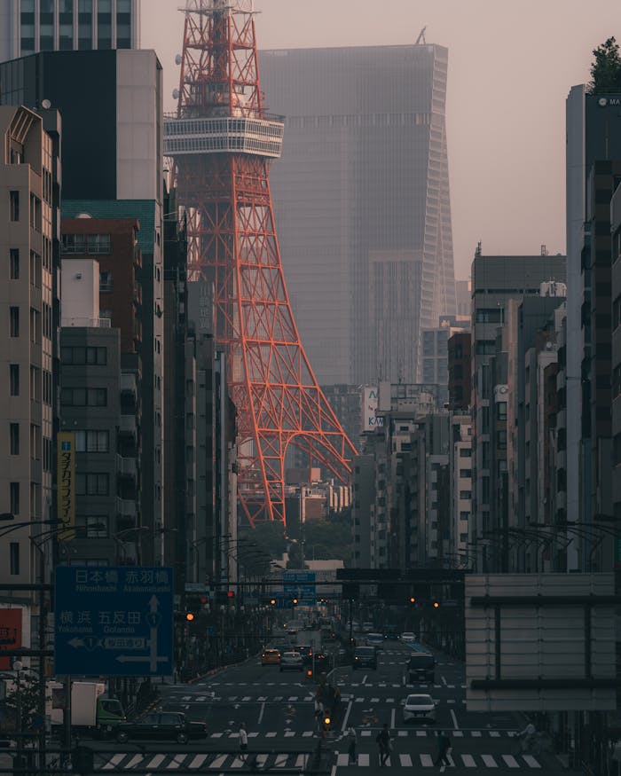 View of Tokyo Tower through bustling Minato City streets at dusk.