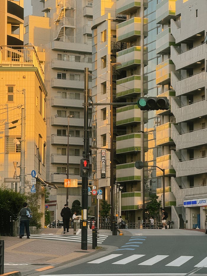 Streetscape in Toshima, Tokyo showcasing modern architecture under warm sunset light.